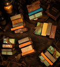 Assorted handmade goat milk soap bars bundled with twine on a rustic wooden surface