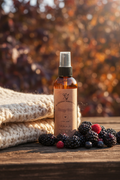 Blackberry Homestead Body Mist on dark wood with fresh blackberries and autumn foliage